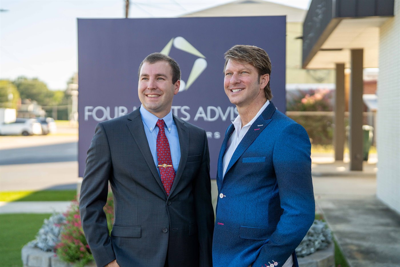 Heath Bartlett and George Skinner of Four Lights Advisors talking outside the office